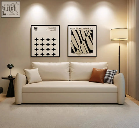 Cream-colored leather tanak two seater sofa bed with clean lines and mixed throw pillows in modern design