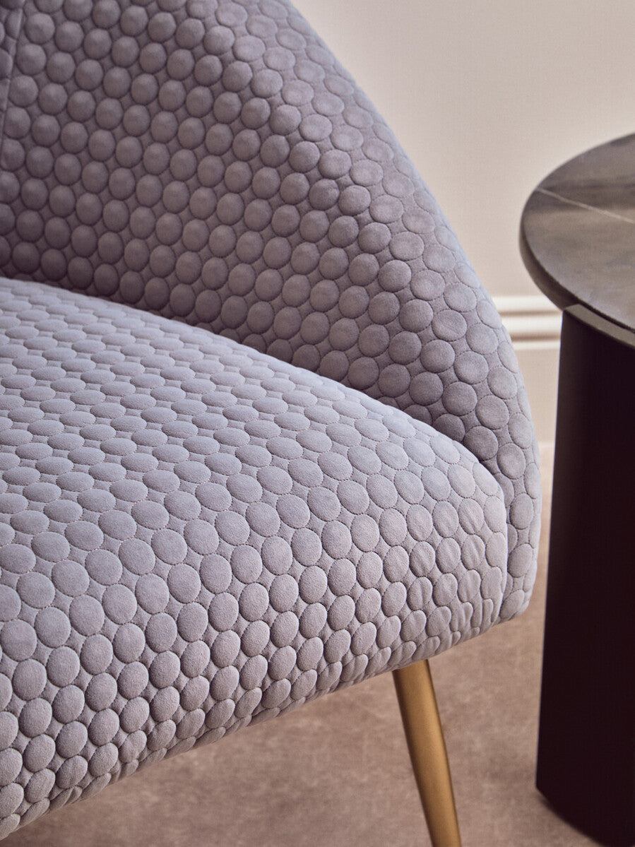 Tania grey occasional chair with gray upholstered textured bubble pattern and slender gold legs for stylish seating
