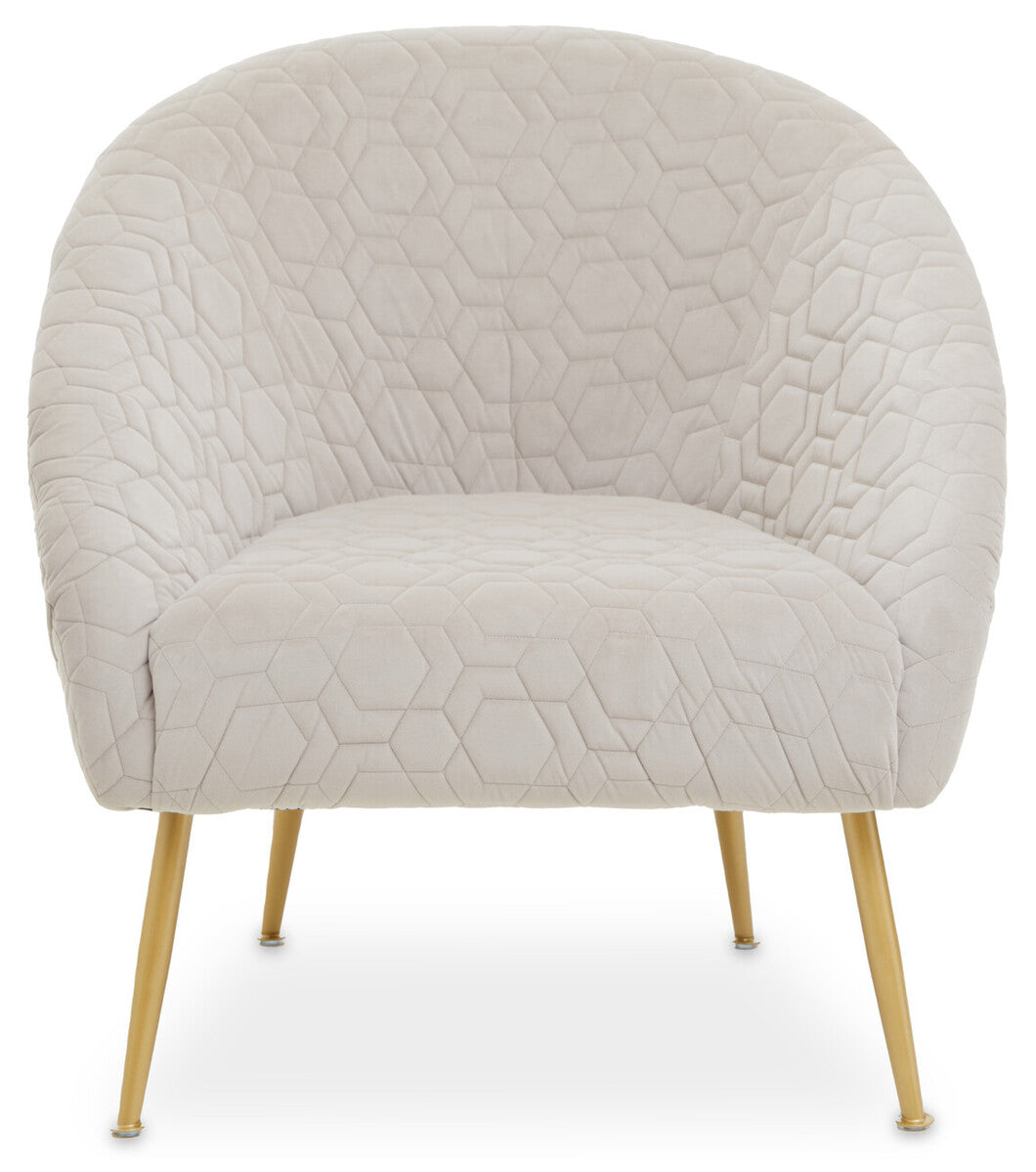 Cream-colored velvet natural occasional chair with quilted hex pattern and slim gold-tone legs perfect for any space