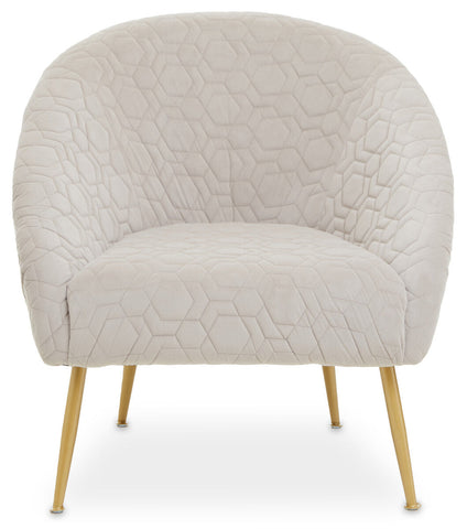Cream-colored velvet natural occasional chair with quilted hex pattern and slim gold-tone legs perfect for any space