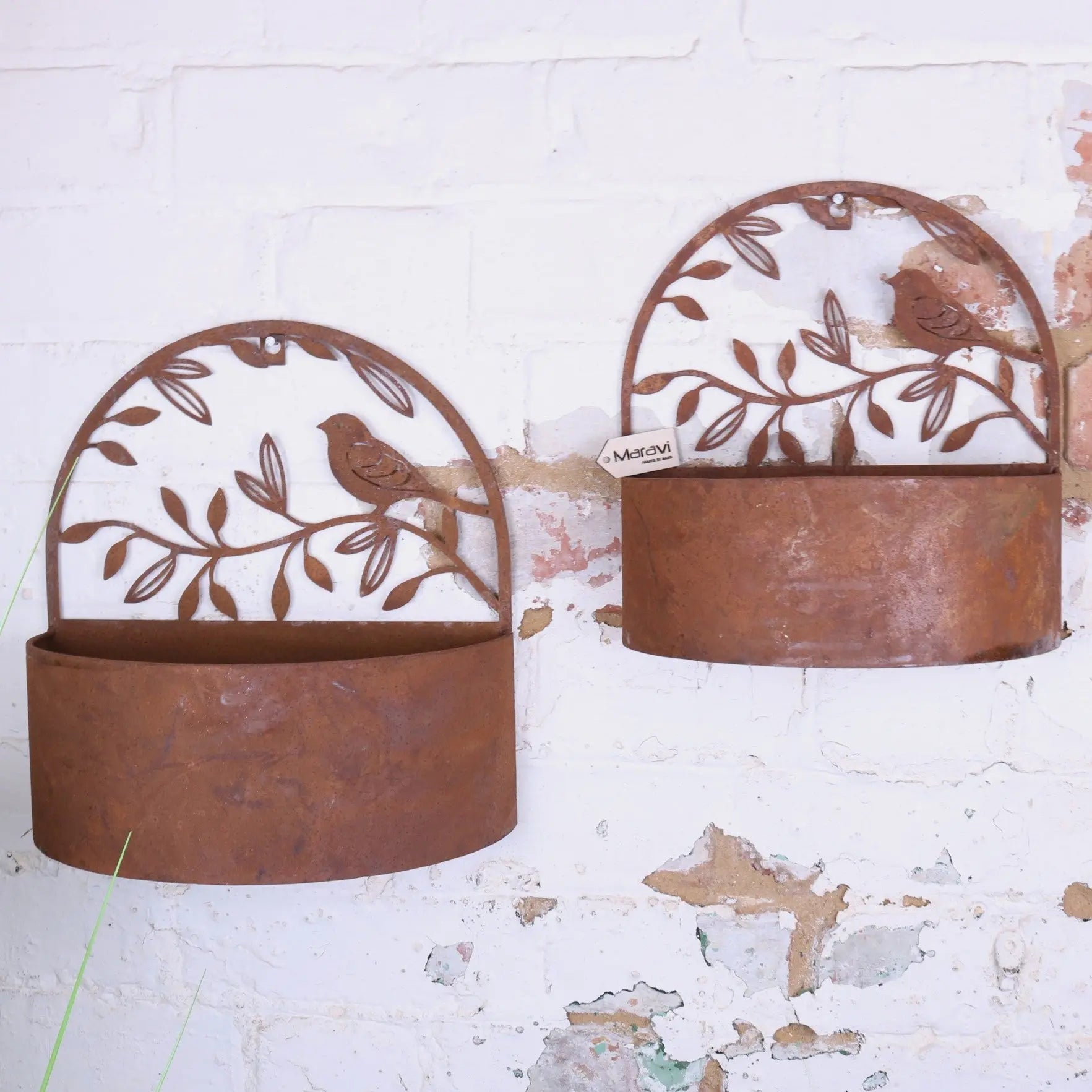 Rust-colored tanu wall mounted metal planters with bird and leaf cut-out designs for stylish plant display