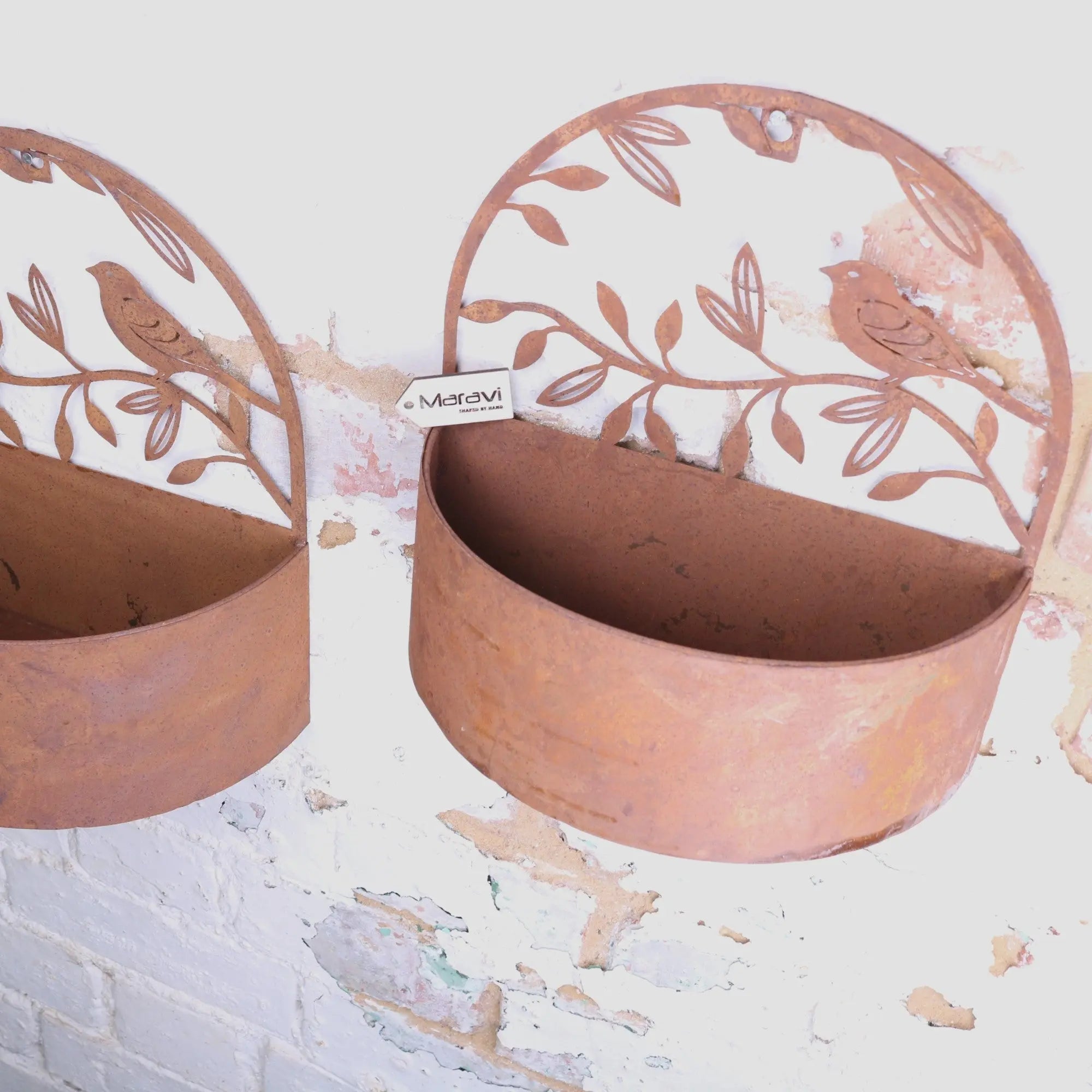 Rustic copper-toned tanu wall mounted metal planter set with cut-out bird and leaf designs in rusted finish