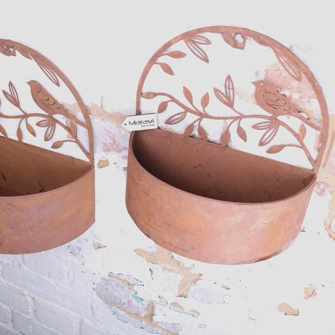 Rustic copper-toned tanu wall mounted metal planter set with cut-out bird and leaf designs in rusted finish