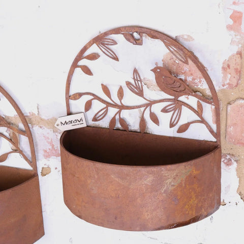 Rustic tanu wall mounted metal planter with bird and leaf design in weathered reddish brown rusted finish