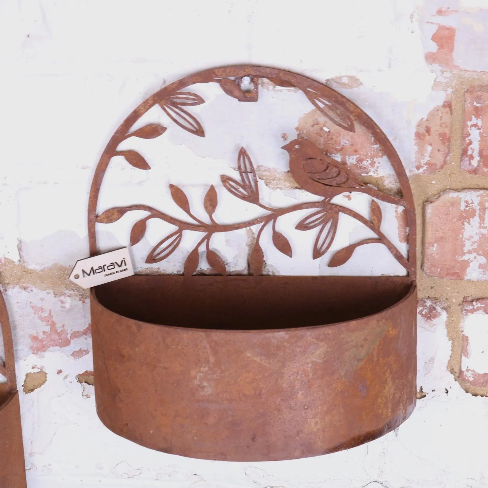 Rustic tanu wall mounted metal planter with bird leaf design and weathered copper finish for indoor outdoor use