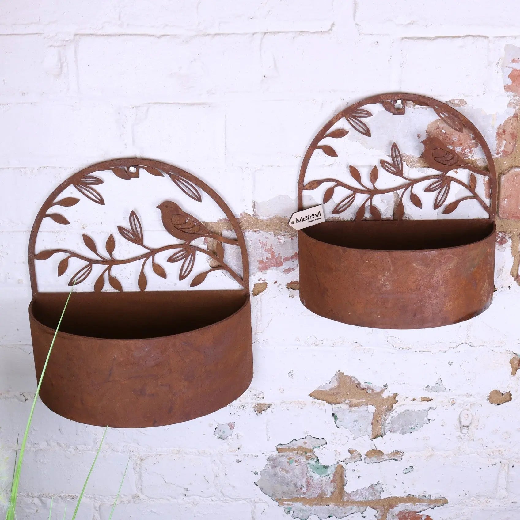 Rustic brown tanu wall mounted metal planters with cut out bird and leaf designs in rusted finish mounted metal planter set