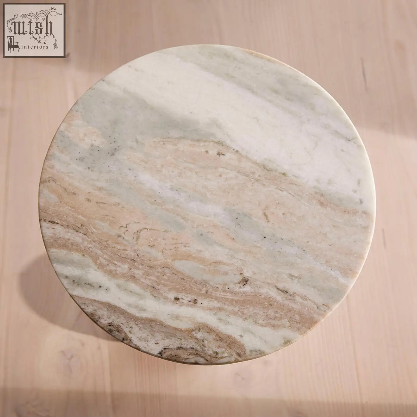 Circular tarantino side table with a white beige and gray marble top and stainless steel base for stylish spaces