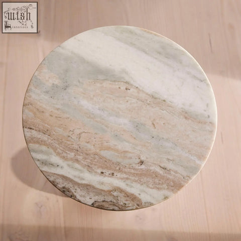Circular tarantino side table with a white beige and gray marble top and stainless steel base for stylish spaces
