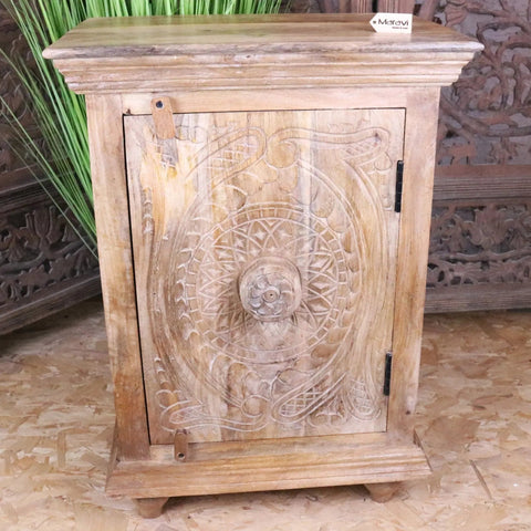 Tarinda carved wooden storage cabinet with hand carved circular floral patterns natural light wood finish and black hinges