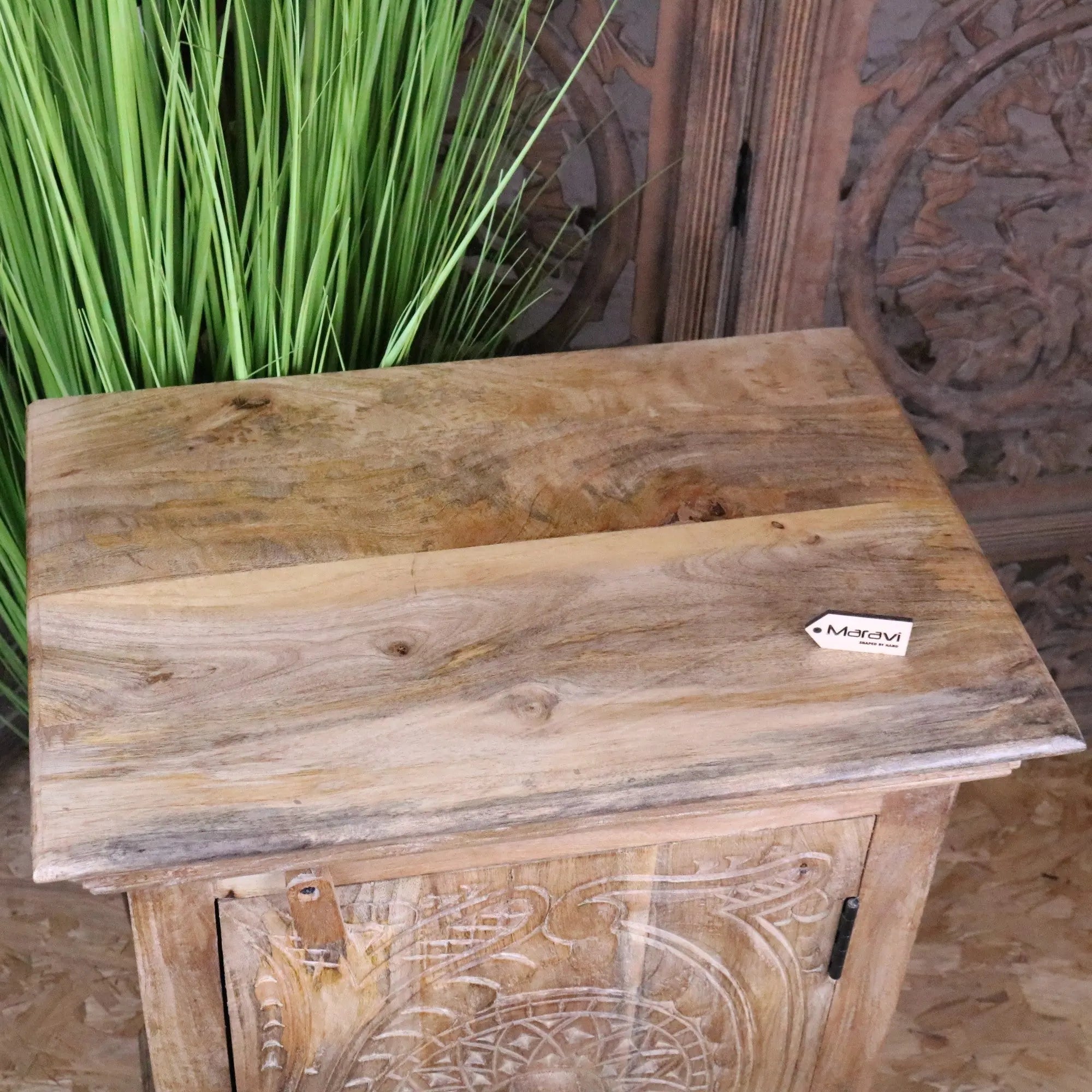 Tarinda carved wooden storage cabinet with hand-carved floral patterns and rustic light brown finish wooden storage cabinet