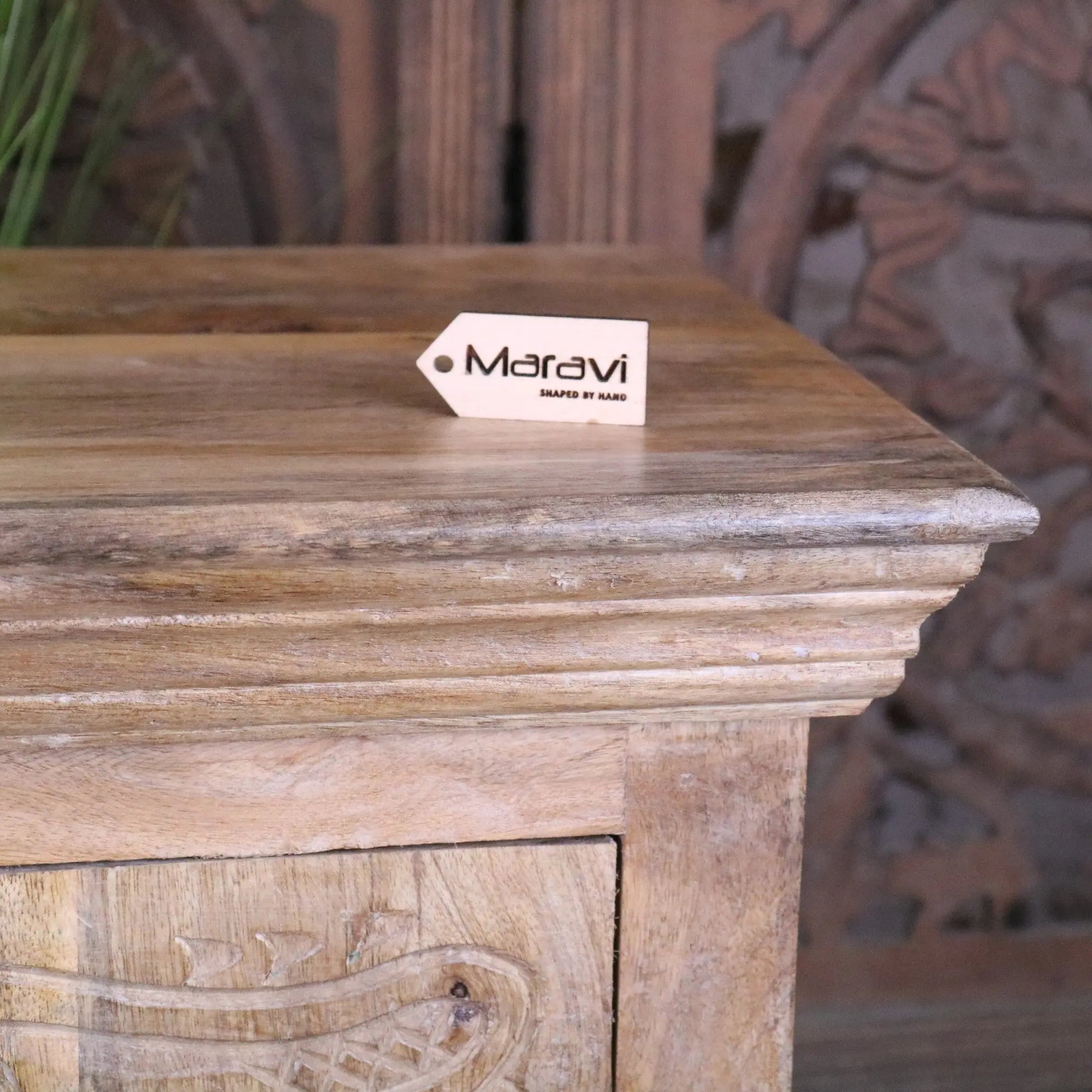 Tarinda carved wooden storage cabinet with rustic weathered finish and intricate relief detailing on front panel