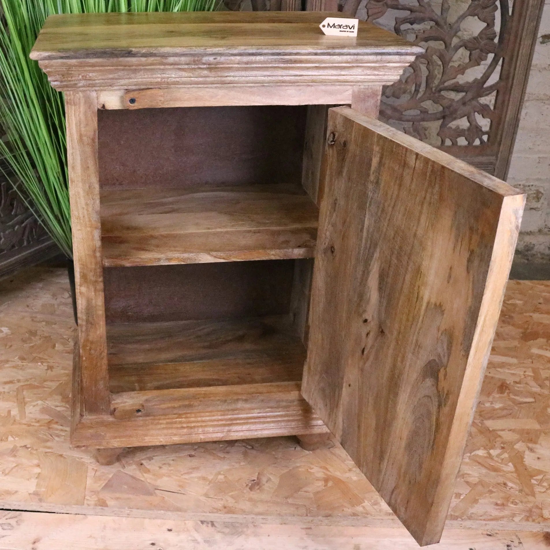 Rustic tarinda carved wooden storage cabinet with a single door and two shelves showcasing natural wood grain