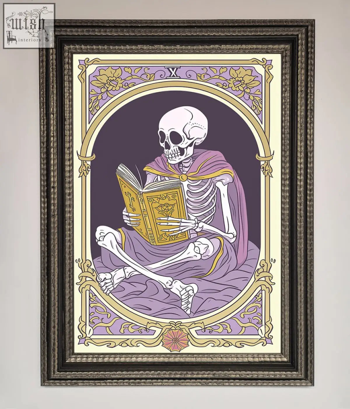 A framed print of a tarot skeleton reader in a purple robe reading an ornate book with gold lavender details
