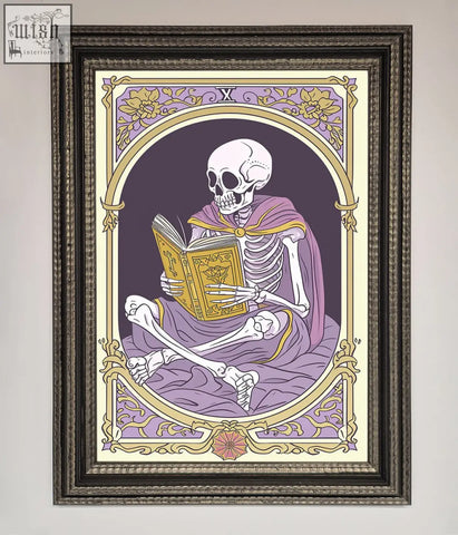 A framed print of a tarot skeleton reader in a purple robe reading an ornate book with gold lavender details