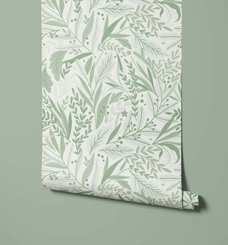 A roll of tate floral wallpaper in light green with delicate leaf and branch patterns on a soft white background