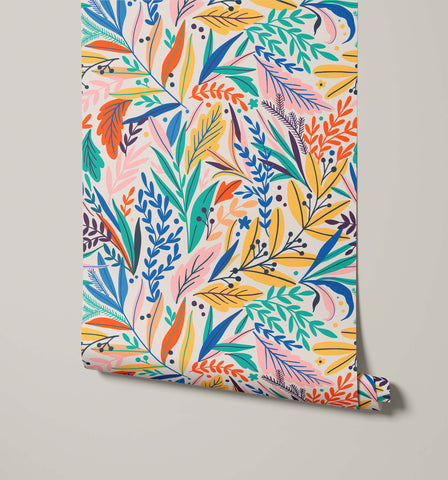 Tate floral wallpaper rolled up with vibrant colorful botanical leaves in blue green orange pink and yellow on white background
