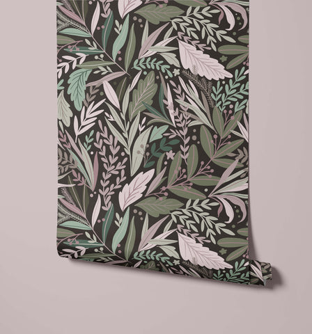 A roll of tate floral wallpaper with dark green background and intricate leaf patterns in muted greens whites and pinks