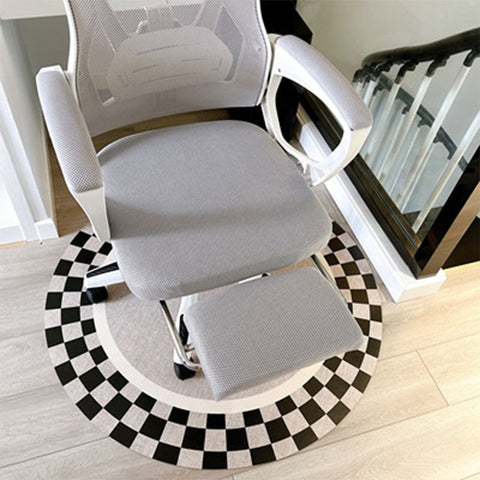 Gray mesh tayona office chair with white armrests and matching footrest on black and white checkered mat