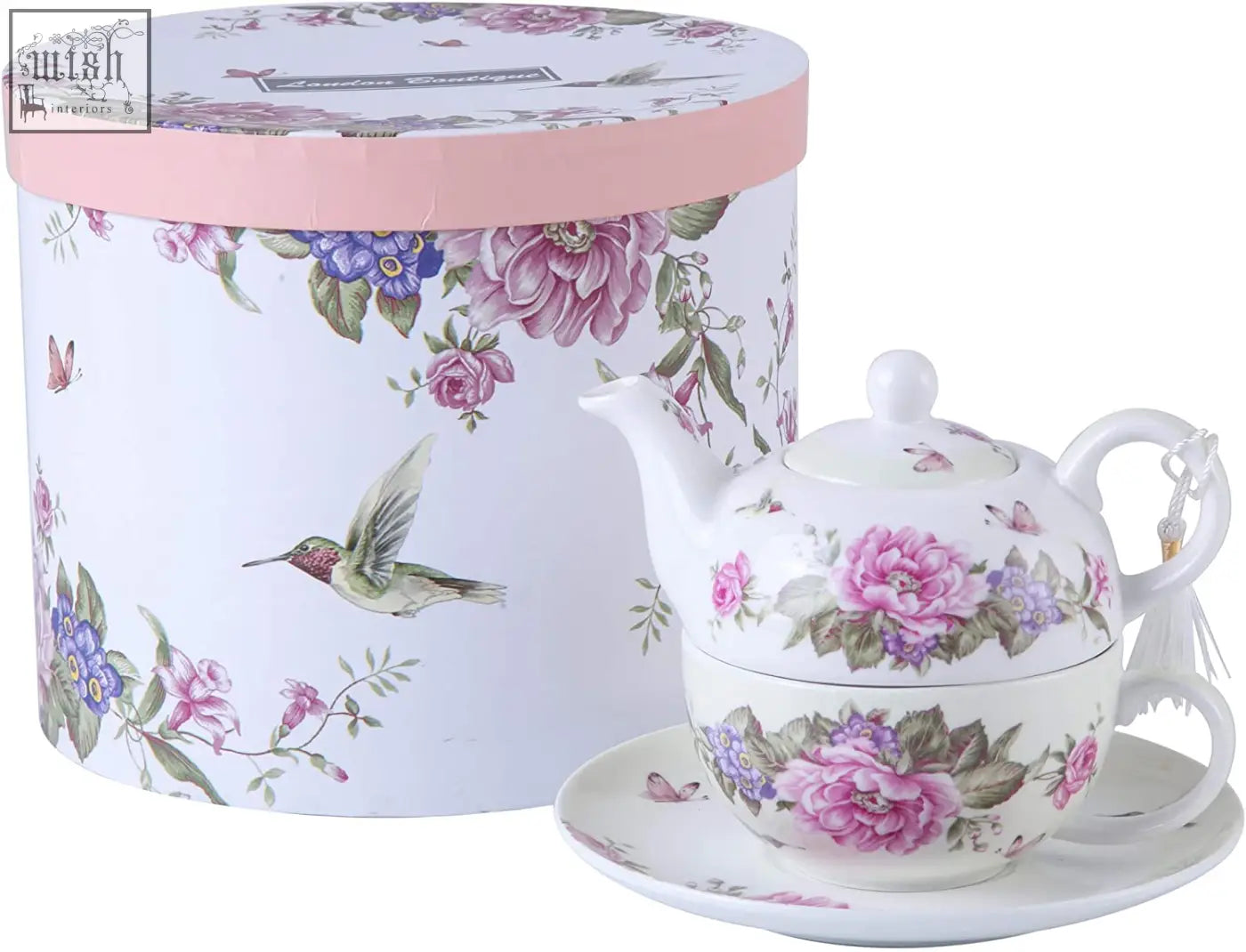 A delicate white ceramic tea for one teapot cup saucer set with floral patterns in a beautiful gift box from london boutique