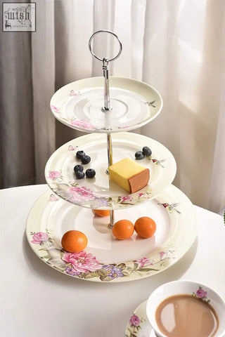 Three-tiered porcelain cake stand with pink and purple floral patterns in a beautiful gift box from london boutique