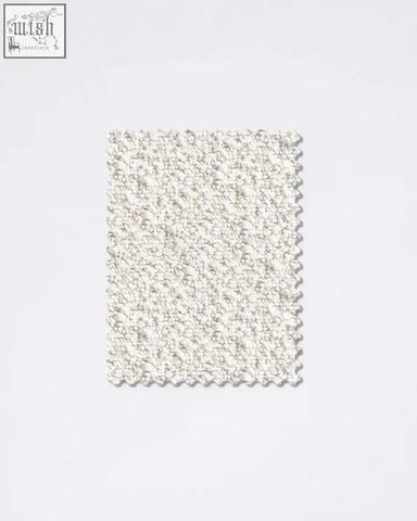 Off-white boucle fabric sample with a plush bumpy texture perfect for cozy upholstery and fashion projects