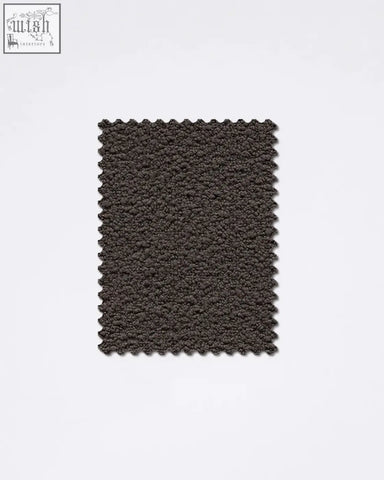 Dark gray teddyc-05 boucle fabric sample with plush textured fuzzy surface and scalloped edges for upholstery or decor