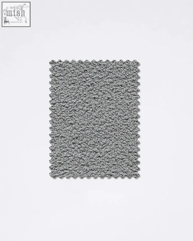 Gray textured bath mat with plush looped pile and scalloped edges made from teddyc-07 boucle fabric sample