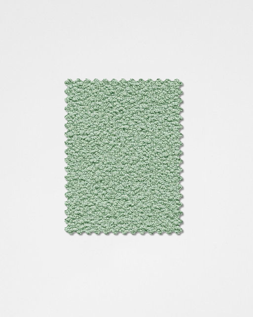 A soft mint-green plush textured rectangular rug with scalloped edge made from boucle fabric sample teddyc-24