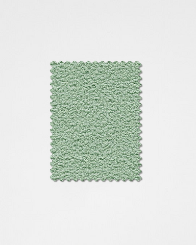 A soft mint-green plush textured rectangular rug with scalloped edge made from boucle fabric sample teddyc-24