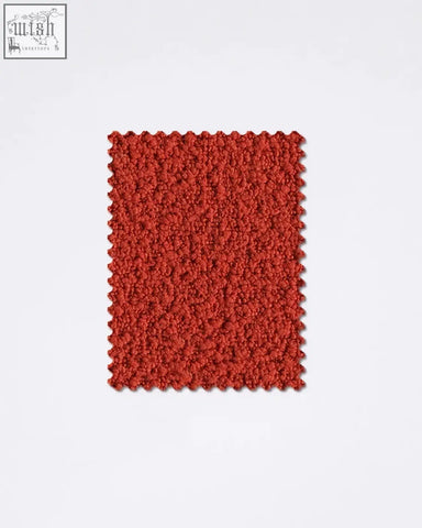 A vibrant red teddyc-27 boucle fabric sample with plush textured surface and scalloped edges perfect for upholstery