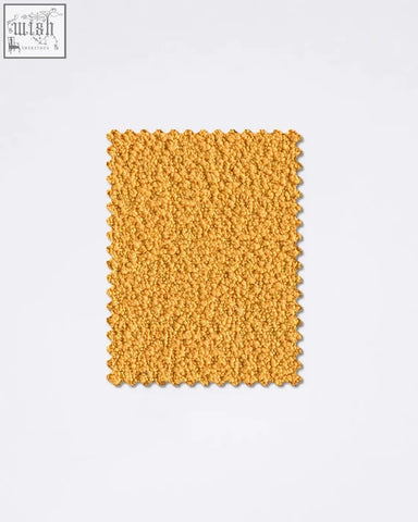 A plush mustard yellow boucle fabric sample rug with soft fuzzy texture and scalloped edges teddyc 31 boucle fabric