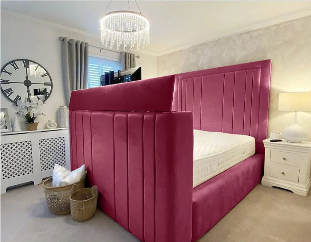 A plush magenta upholstered telly bed with a tall tufted headboard and footboard perfect for small double rooms fits tvs