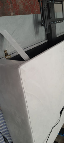 White upholstered media console with metal hardware and sleek design that fits tvs in the telly bed small double setup
