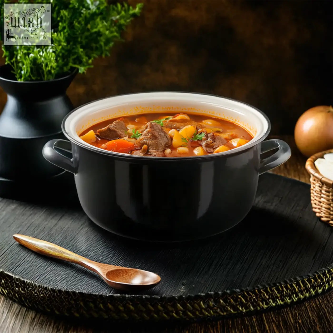 Black deep fryer telo with enameled cast iron pot filled with hearty beef stew for deep frying and cooking