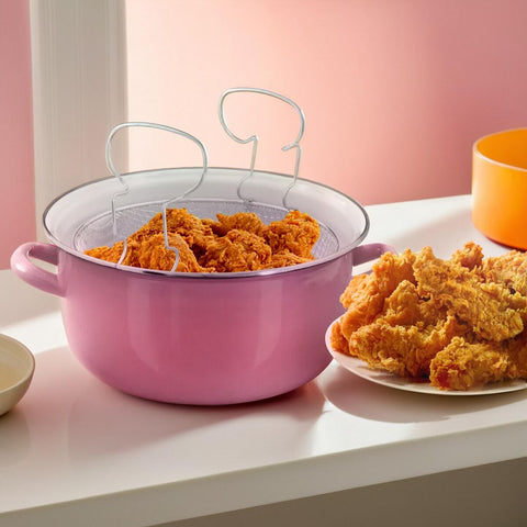 Pink enamel telo pink deep fryer with wire mesh strainer holding golden brown fried chicken pieces