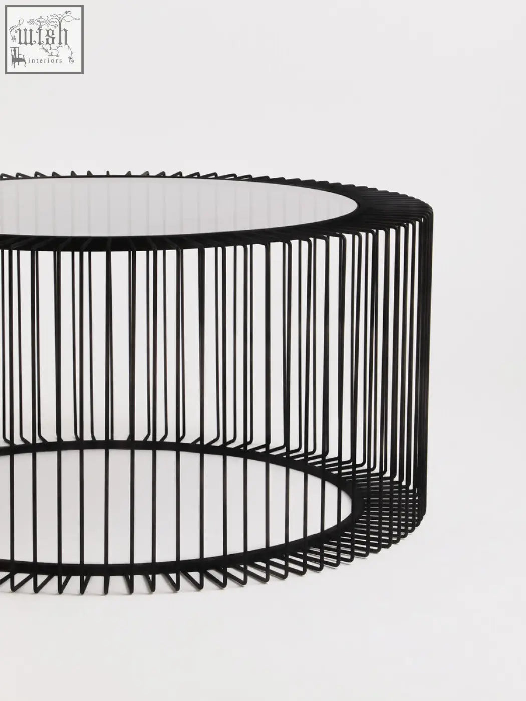 Black metal wire round coffee table with tempered glass top and modern wireframe cage base trento design