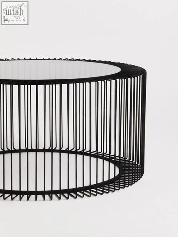 Black metal wire round coffee table with tempered glass top and modern wireframe cage base trento design