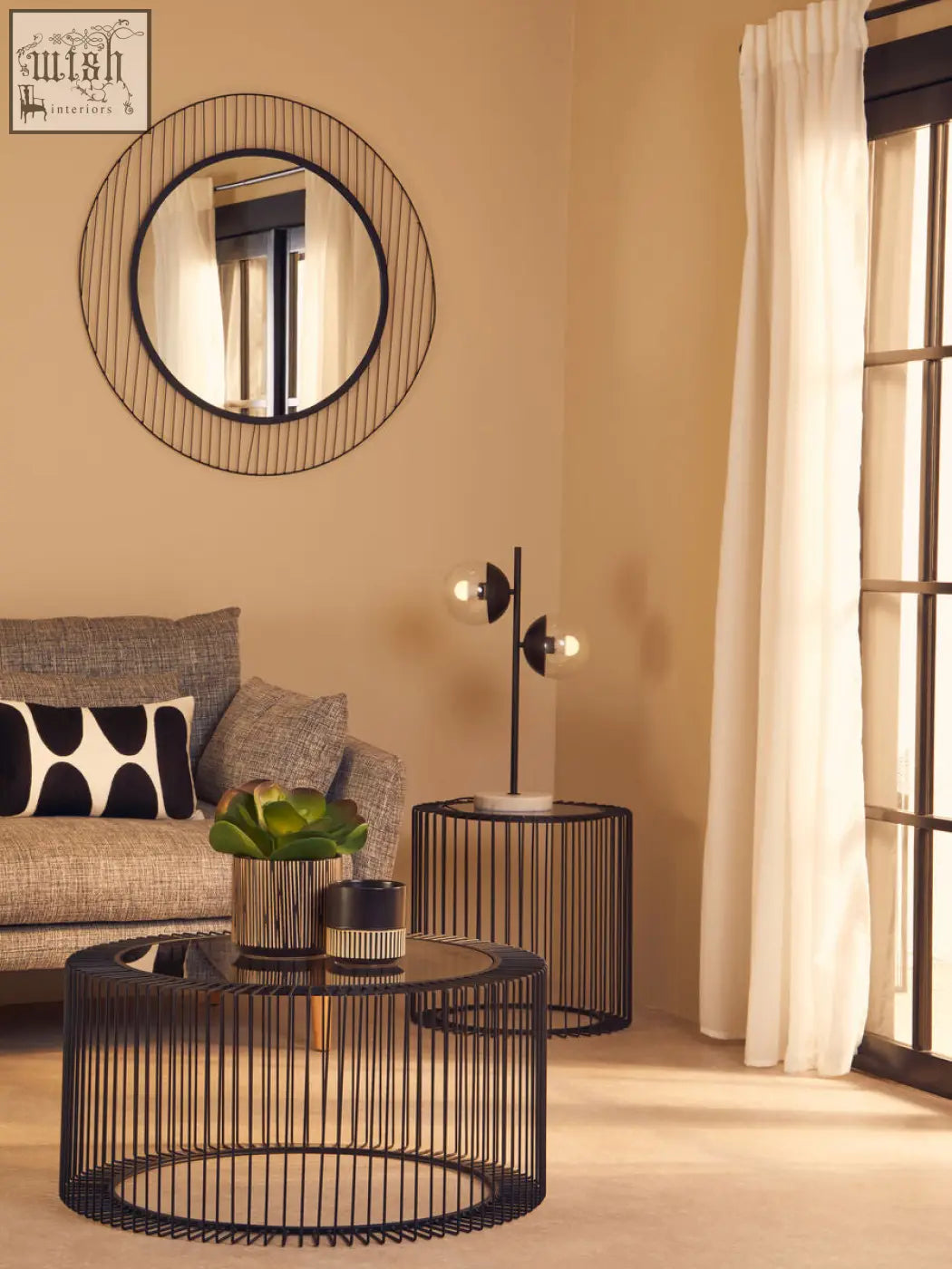 Black wireframe round coffee table with tempered glass top and cage design base perfect for living rooms