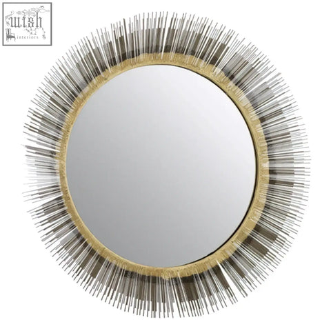 Templar brass finish wall mirror with a circular sunburst design and gold-toned frame featuring silver spikes