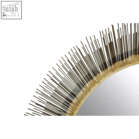 Templer brass finish wall mirror with golden sunburst design and metallic spikes radiating from reflective surface