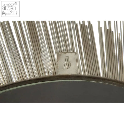 Templar brass finish wall mirror with silver sunburst design, slender metallic rays, and subtle engraved logo at center