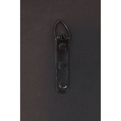 Black metal wall hook with three holes and looped top on back of rectangular wall mirror for easy hanging