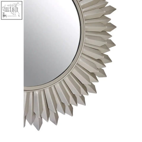 Templar sunburst wall mirror with silver faceted rays creating a striking sunburst wall mirror design