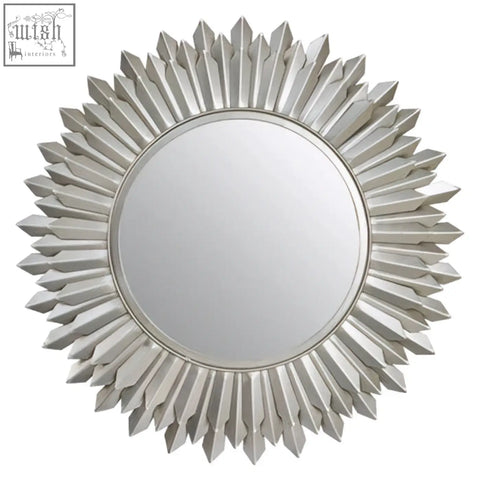 Templar sunburst wall mirror with a silver metallic faceted frame radiating from a central circular glass sunburst wall mirror