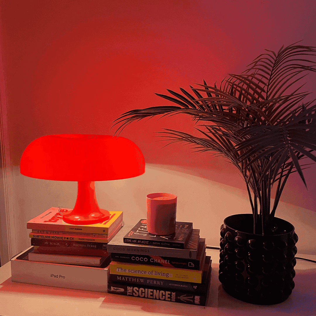 Vibrant red ambient mushroom desk lamp shaped like a mushroom providing cozy lighting for any desk space