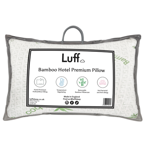 The bamboo hotel premium pillow is white with gray trim woven texture and green bamboo leaf patterns on soft fabric