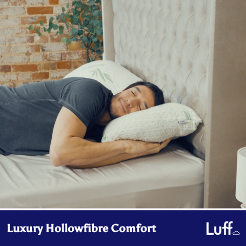 The bamboo hotel premium pillow is a white breathable hollowfiber pillow with green bamboo leaf embroidery and quilted texture