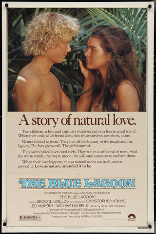Vintage blue lagoon movie poster featuring a romantic scene of two young lovers in tropical foliage