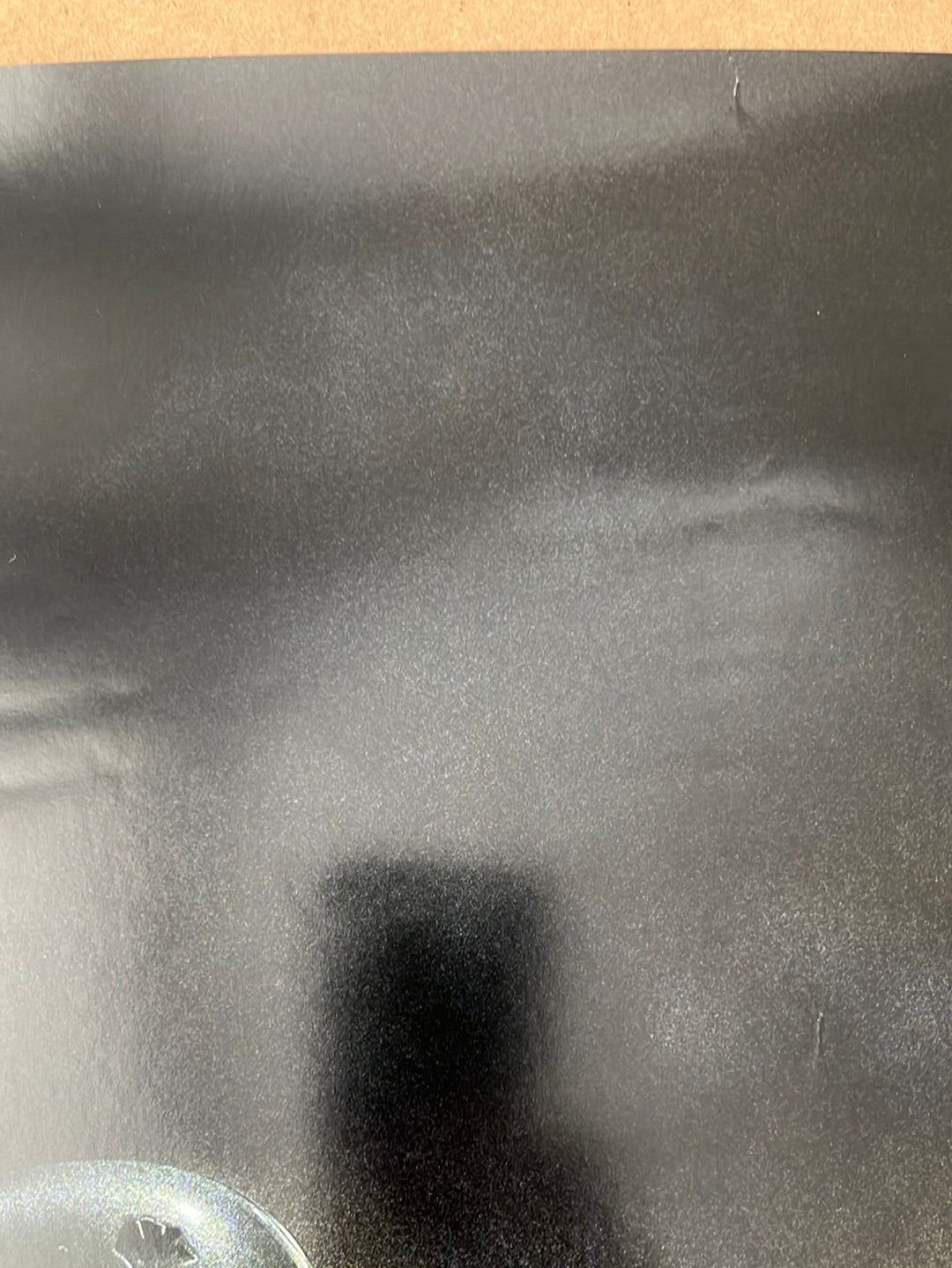 Black matte finish plastic surface with subtle texture and reflections on the book of boba fest 2021 star wars poster