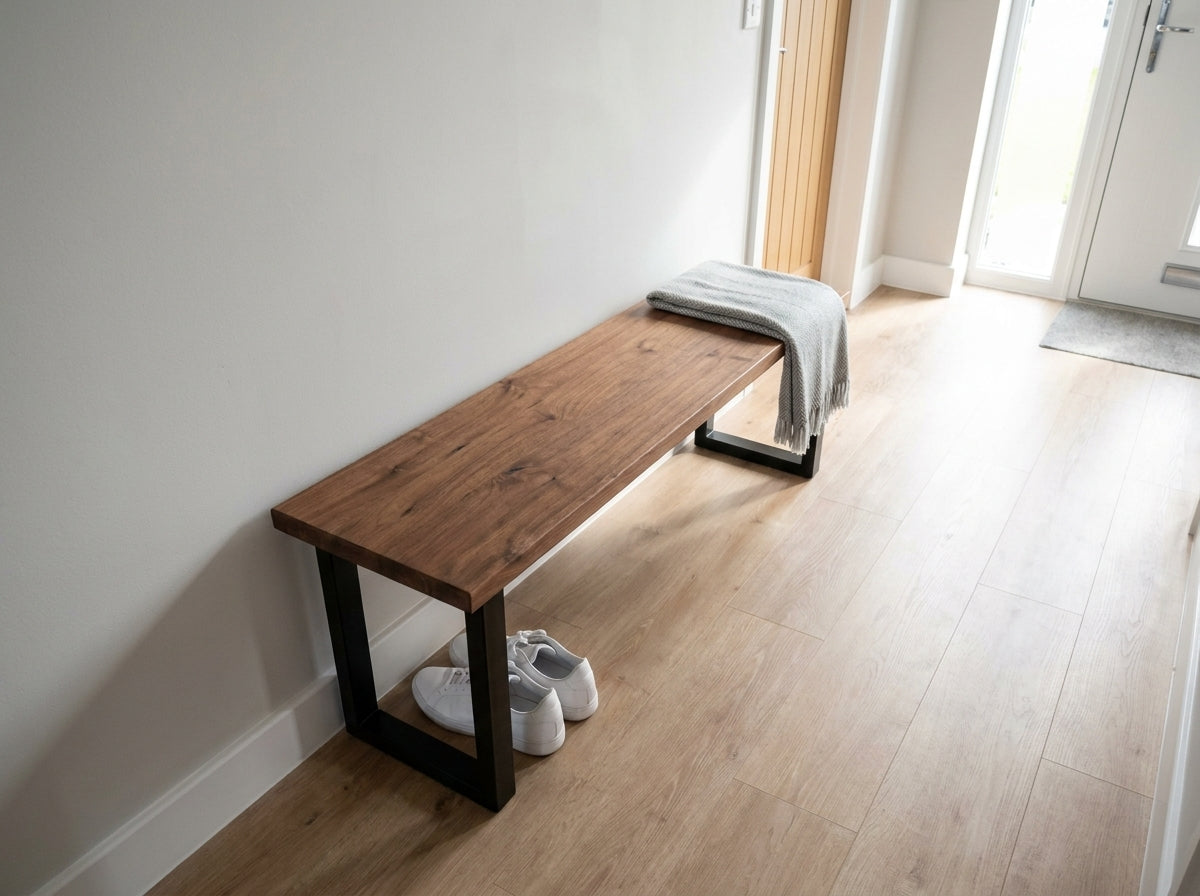 A bruton bench with sleek black metal legs and natural walnut wooden seat from the bruton range with minimalist design